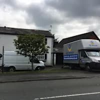 JMC Removals vehicles at depot in Warrington — house clearance service